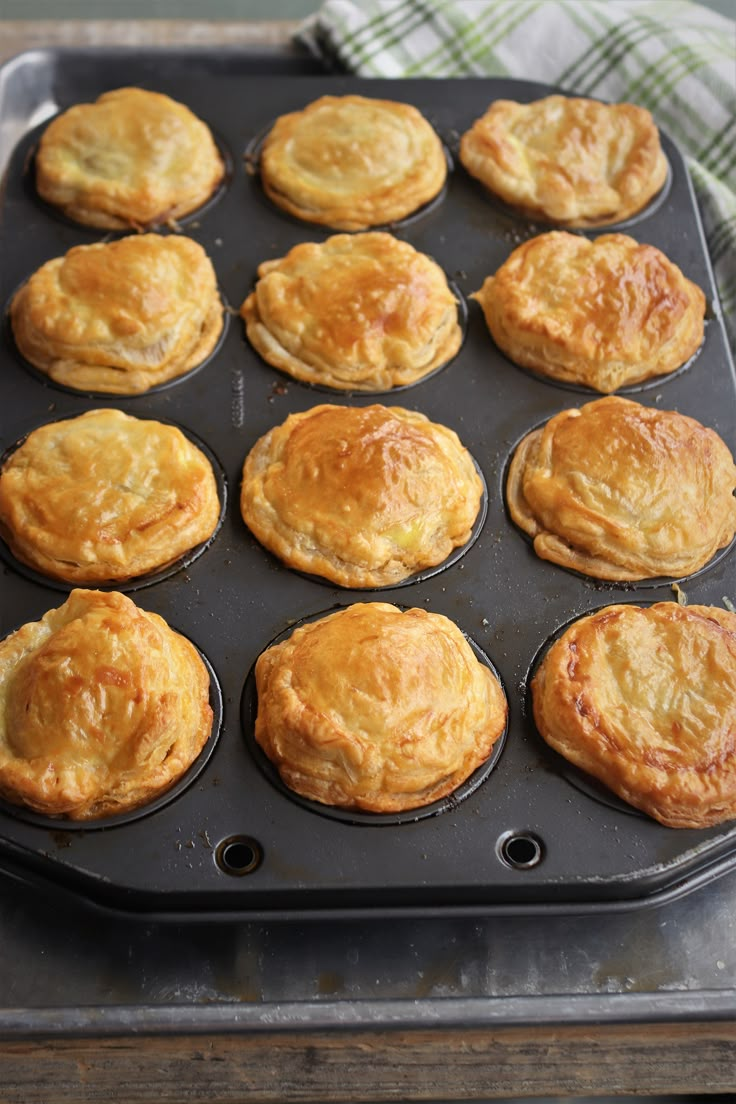 a muffin tin filled with baked goods on top of a table