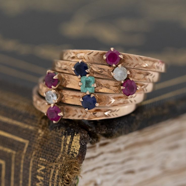 Harem rings come to us from the Victorian era, with a few different theories as to how they came into existence. They are made from 5 smaller bands. All mechanically joined together to create one wider band, often dotted with baby gemstones for a “confetti” appearance. Ours is in vintage rose gold, with the juiciest and brightest little gemstones! This ring is perfect for one who loves to fidget and play with their jewelry - the bands all individually hinge and move around in the most fun way. 1 14k Gold Multi-stone Stackable Rings, Fine Jewelry Multi-stone Stackable Rings With Round Band, Heirloom Style Stackable Emerald Ring, Heirloom Multi-stone Round Cut Birthstone Ring, Heirloom Birthstone Ring With Bezel Setting, Heirloom Ruby Ring For Promise, Heirloom Style Promise Stackable Rings, Heirloom Ruby Promise Ring With Round Band, Heirloom Sapphire Ring With Round Band