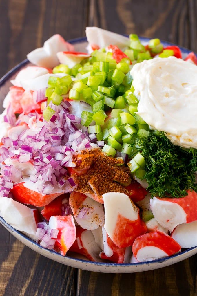 a bowl filled with vegetables on top of a wooden table