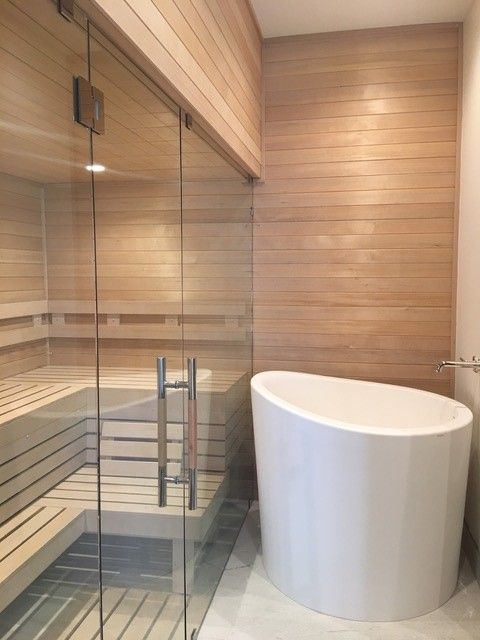 a large white bath tub sitting inside of a bathroom next to a walk in shower