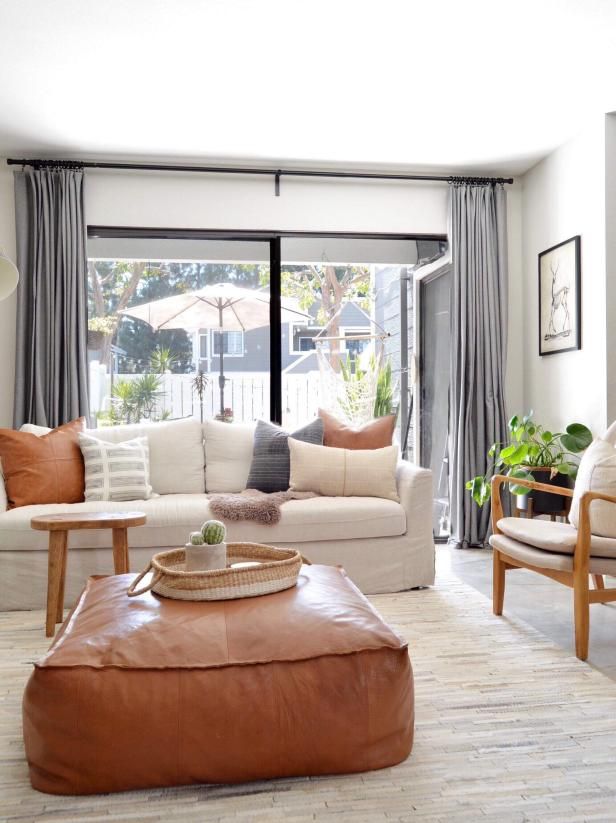 a living room filled with furniture and a large window