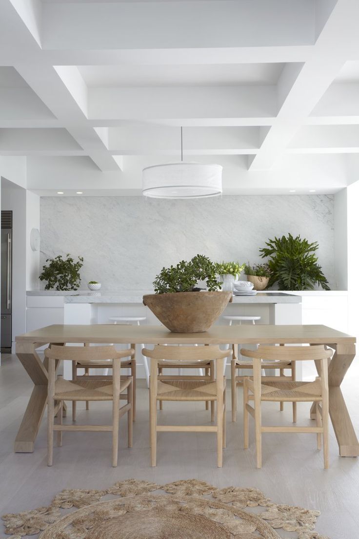 a dining room table with chairs and a bowl on it