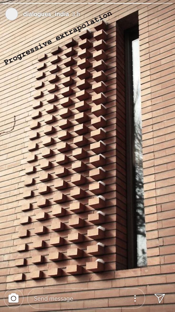 the side of a brick building with an open window on it's side, made out of bricks