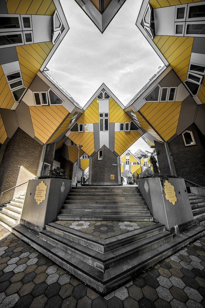 an artistic view of some stairs with yellow and white buildings in the backgroud