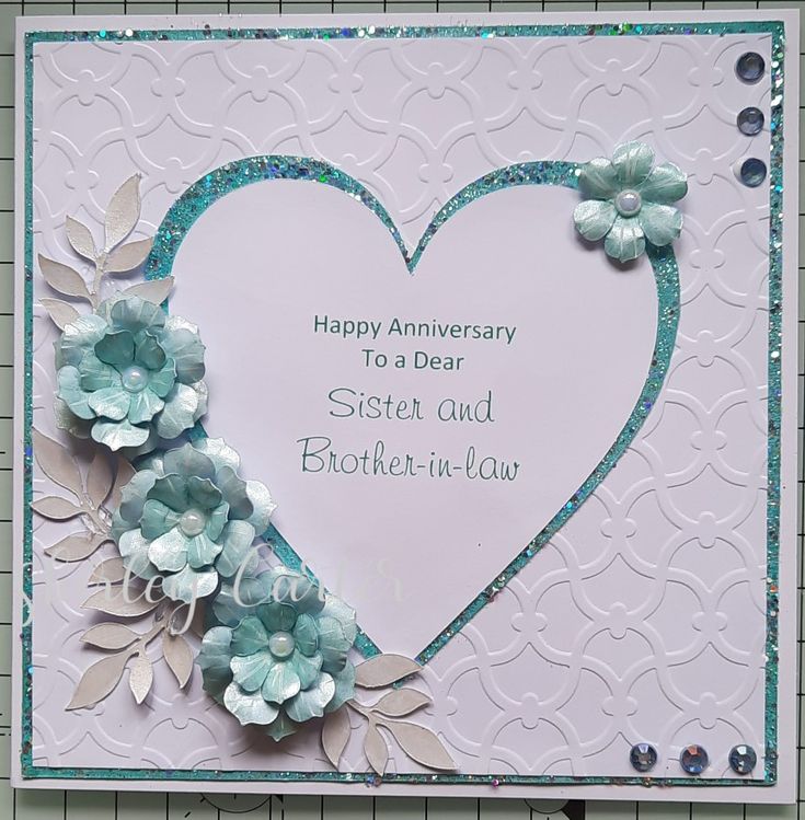 a birthday card with flowers on it and a heart in the middle that says happy anniversary to a dear sister and brother - in - law