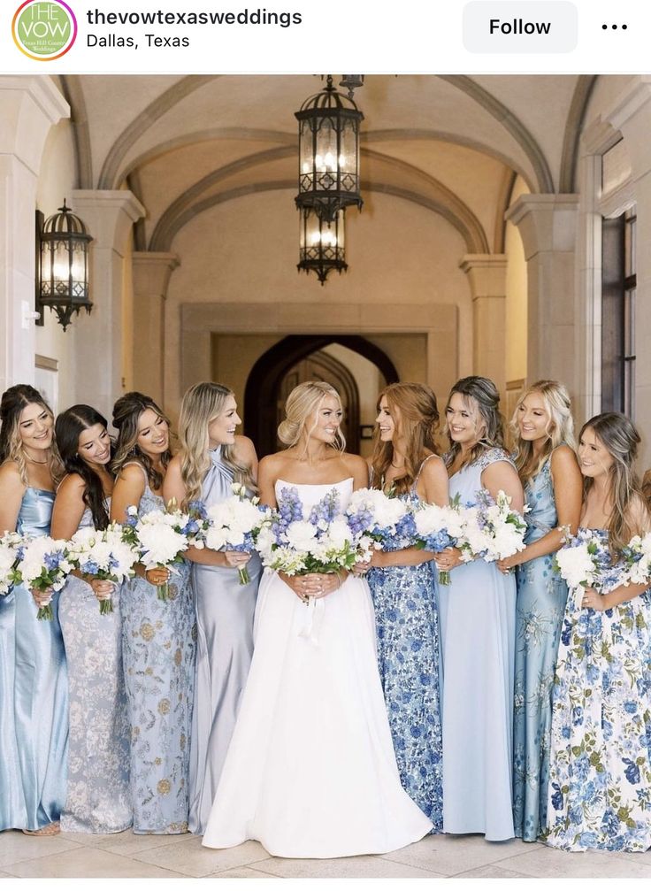 a group of women standing next to each other in front of a doorway holding bouquets