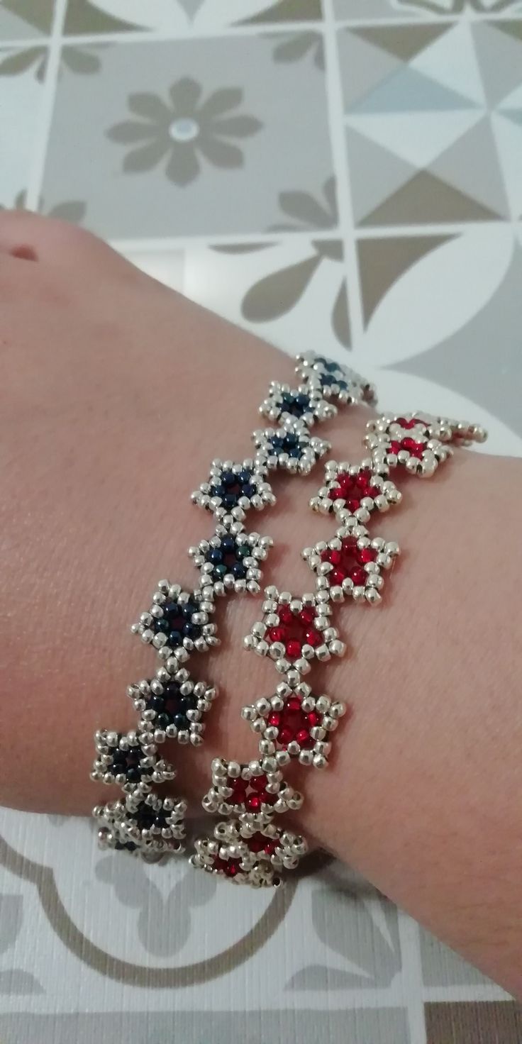 a woman's arm with red, white and blue beads on it