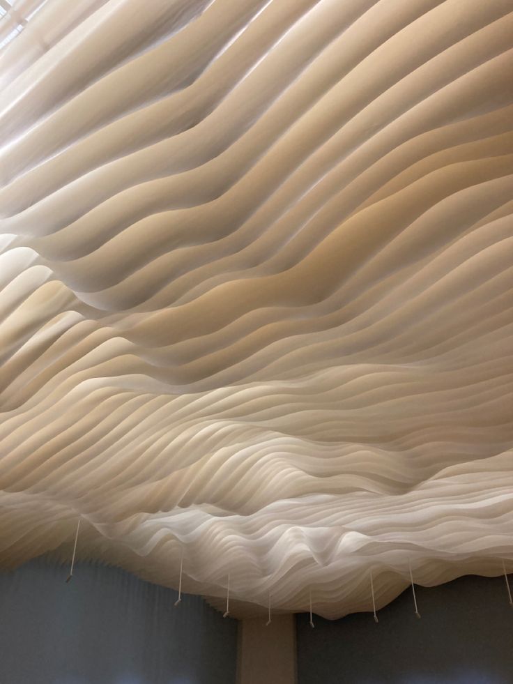 the ceiling is made up of wavy white material