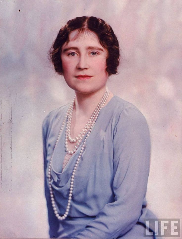 an old photo of a woman wearing pearls