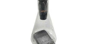 an old cell phone in a glass bottle