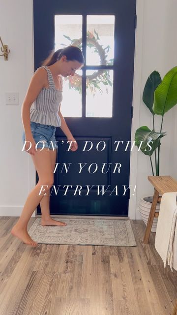 a girl standing in front of a door with the words don't do it in your entry way