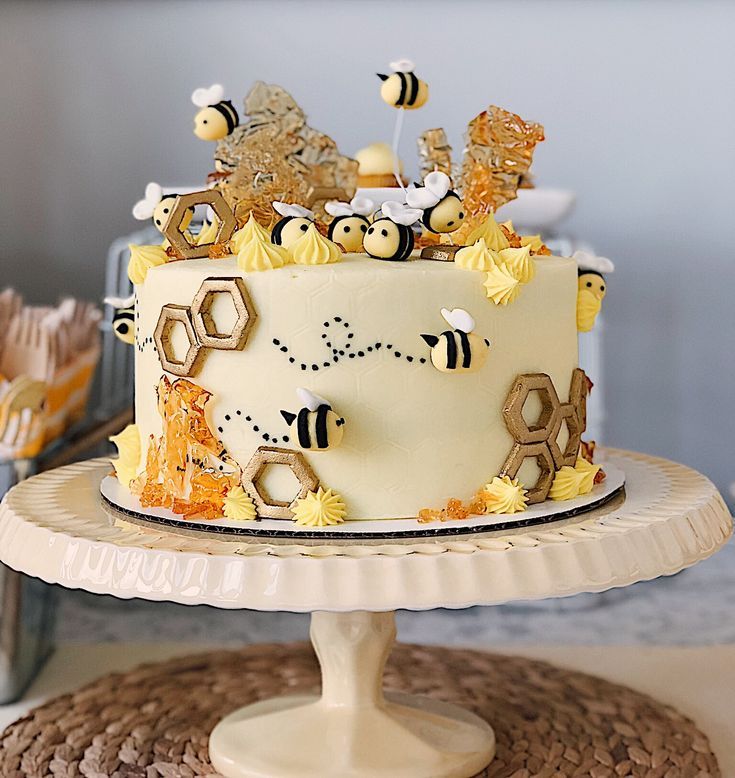 a cake with bees and honeycombs on it sitting on top of a table