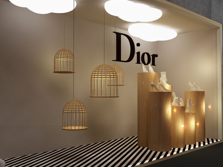 a dior store window with lights hanging from it's sides