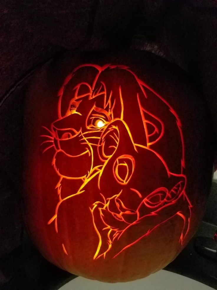 a pumpkin carved to look like an image of cartoon characters