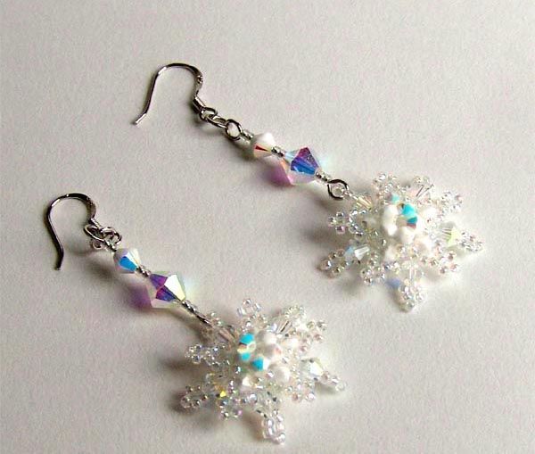 the earrings are made out of glass beads and swarong crystal flowers on them