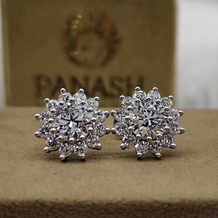 These exquisite moissanite halo stud earrings feature brilliant round cut diamonds surrounded by a shimmering halo, set in luxurious 14k yellow or white gold. Designed with secure push back studs, these earrings are perfect for weddings, special occasions, or adding a touch of elegance to everyday wear. The radiant moissanite and diamond combination ensures a captivating sparkle, while the classic halo design adds timeless sophistication. Ideal for women who appreciate fine jewelry, these earrin Anniversary Halo Cluster Earrings, Halo Design Cluster Earrings For Anniversary, Halo Design Cluster Earrings In Cubic Zirconia, Anniversary Cluster Earrings With Halo Setting, Anniversary Cluster Diamond Earrings With Halo Setting, Cluster Halo Diamond Earrings For Anniversary, Round Cut Diamond Earrings With Halo Setting For Gift, Diamond White Halo Design Cluster Earrings, Classic Moissanite Earrings With Halo Setting