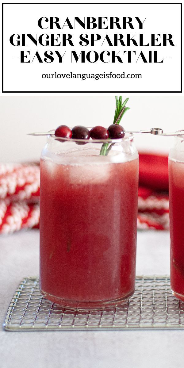 two glasses filled with cranberry ginger sparkler cocktail on a wire cooling rack