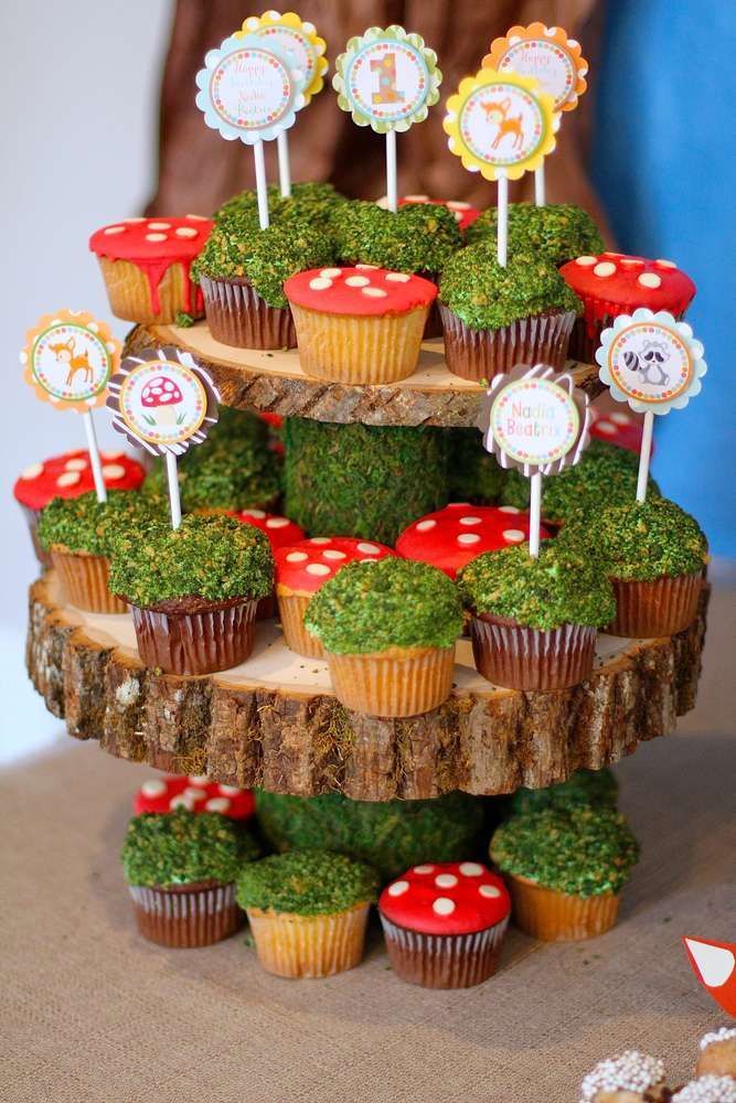 cupcakes are stacked on top of each other in the shape of trees and mushrooms