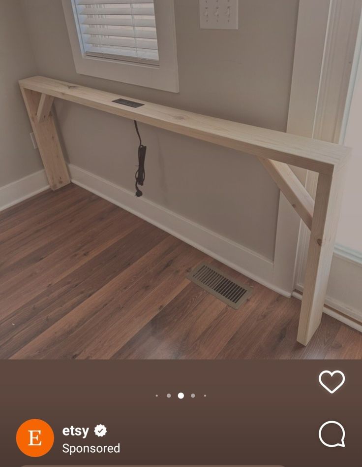 a wooden bench sitting on top of a hard wood floor next to a white door