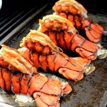 lobsters are being cooked on an outdoor grill