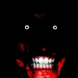 an image of a scary face with teeth and fangs in the dark, glowing red