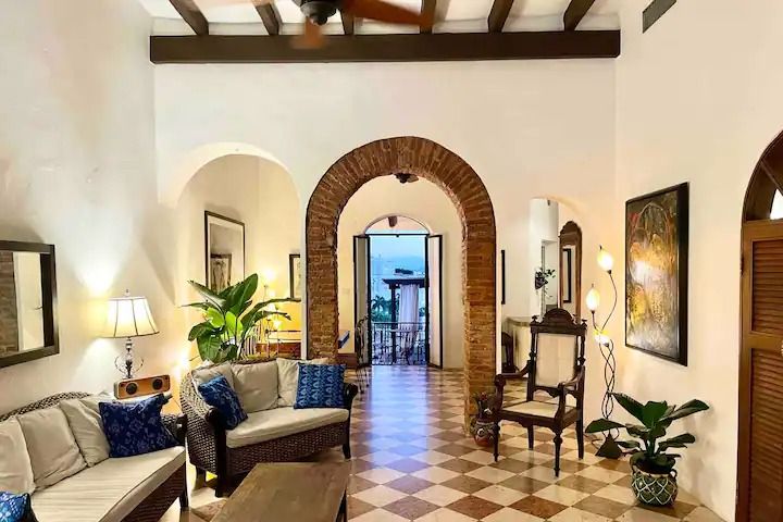 a living room filled with furniture and lots of windows