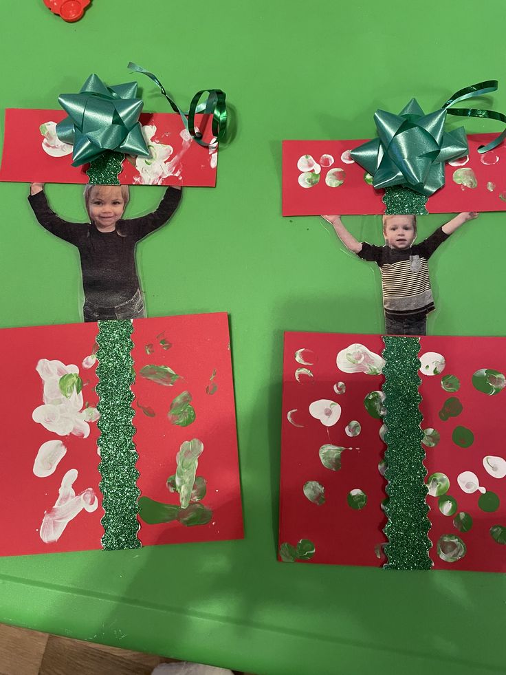 two children wearing green bows on top of red and green paper with silver confetti