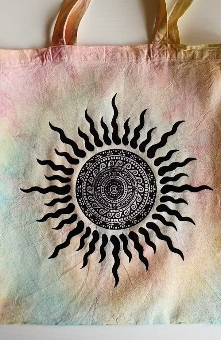 a bag with an image of the sun painted on it's front and sides