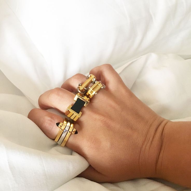 Metal movement. The One Finger Two Finger Ring features three geometric pieces with a precious stone fastening them together form one elegant ring or two with a simple flip of the finger. Pair with the Big Block Ring for a bold gemstone statement or the Hinge Ring for an industrial touch. Tap now to shop! #Minimalistic #Simple #Chic #Elegant #Luxury #Modern #nyc #Fashion #Classy #Trendy #Jewelry #angle #rings #collections #new #style #accessories #silver #gold  #gift #design #gemstone Two Finger Ring, Hinged Ring, One Finger, Accessories Silver, Gift Design, Gold Gift, Simple Chic, Black Agate, Nyc Fashion