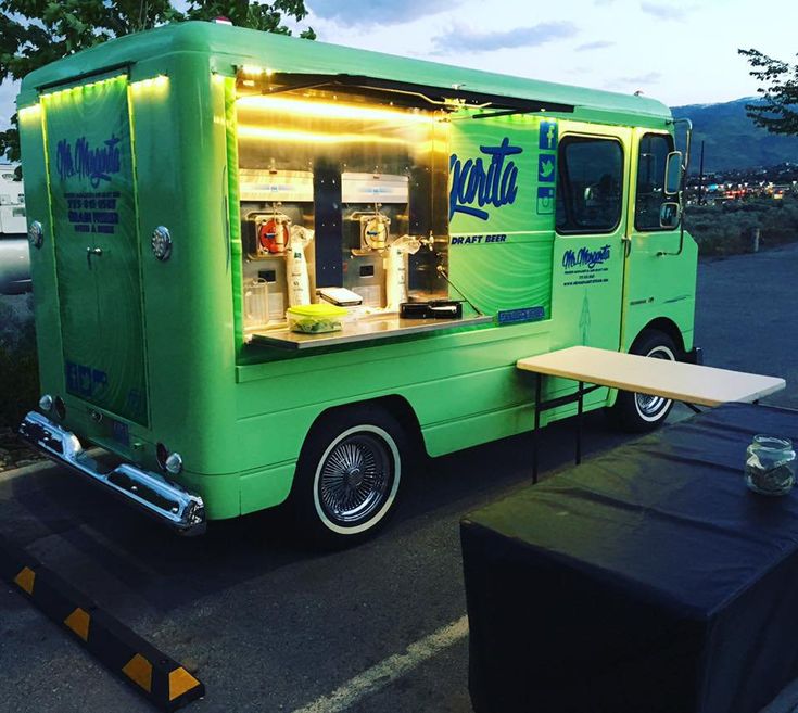 an ice cream truck is parked on the side of the road with its door open