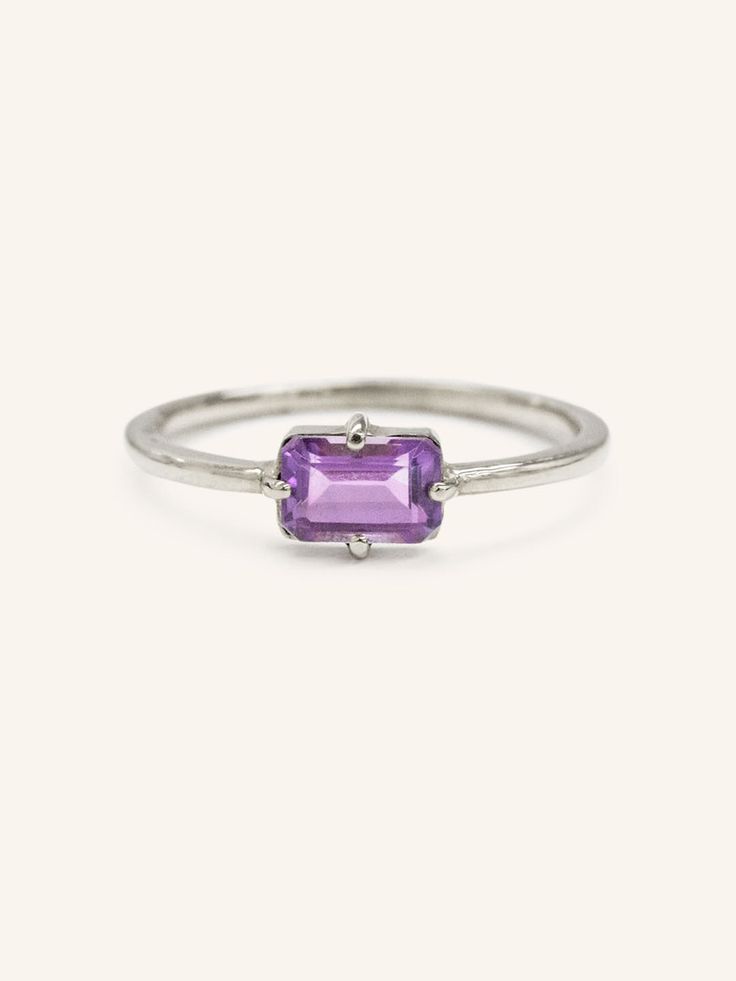 A unique spin on a modern classic. The Lady's Mantle Amethyst ring stuns with an amethyst center stone of a rich purple. It's a great present for those born in the month of love, February. Fine Jewelry Pink Sapphire Ring In Purple, Elegant Purple Amethyst Ring With Bezel Setting, Timeless Purple Rings As Gifts, Elegant Purple Amethyst Bezel Setting Ring, Timeless Purple Rings For Gifts, Timeless Purple Rings Perfect For Gifts, Modern Emerald Cut Amethyst Ring Gift, Modern Emerald-cut Amethyst Ring Gift, Purple Pink Sapphire Ring With Center Stone