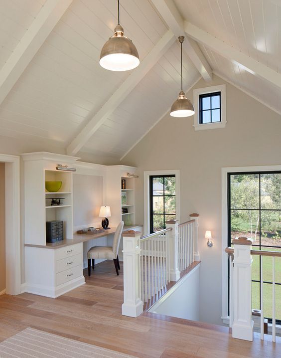 an open concept living room with white walls and wood floors