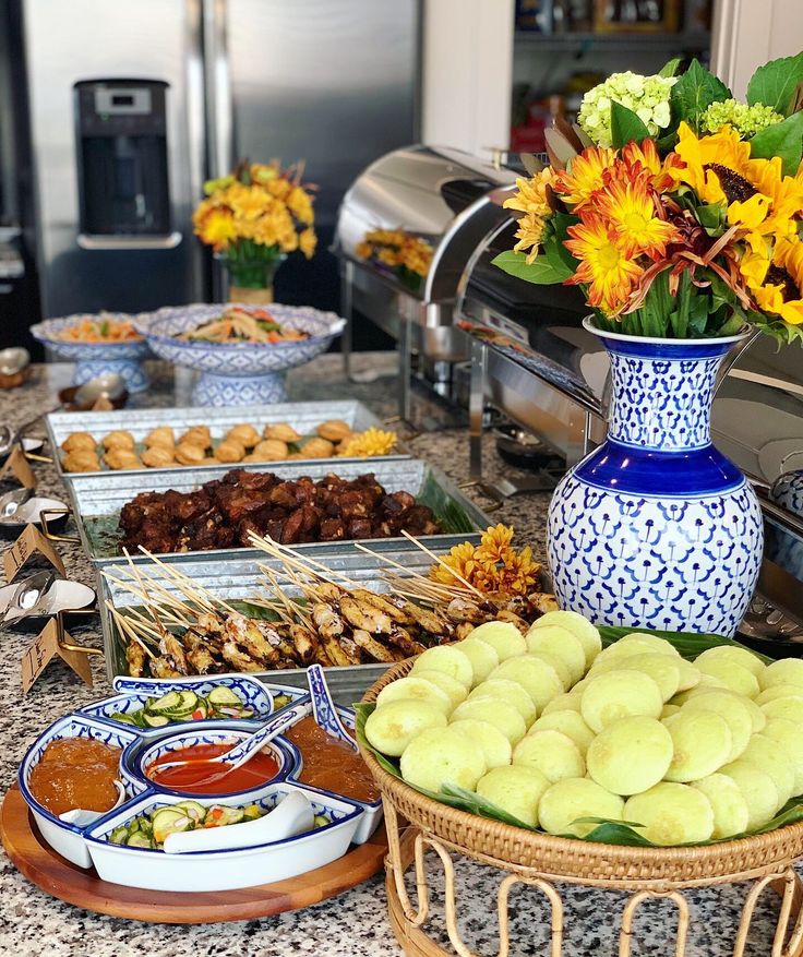 an assortment of food is displayed on a countertop in a restaurant or buffet area