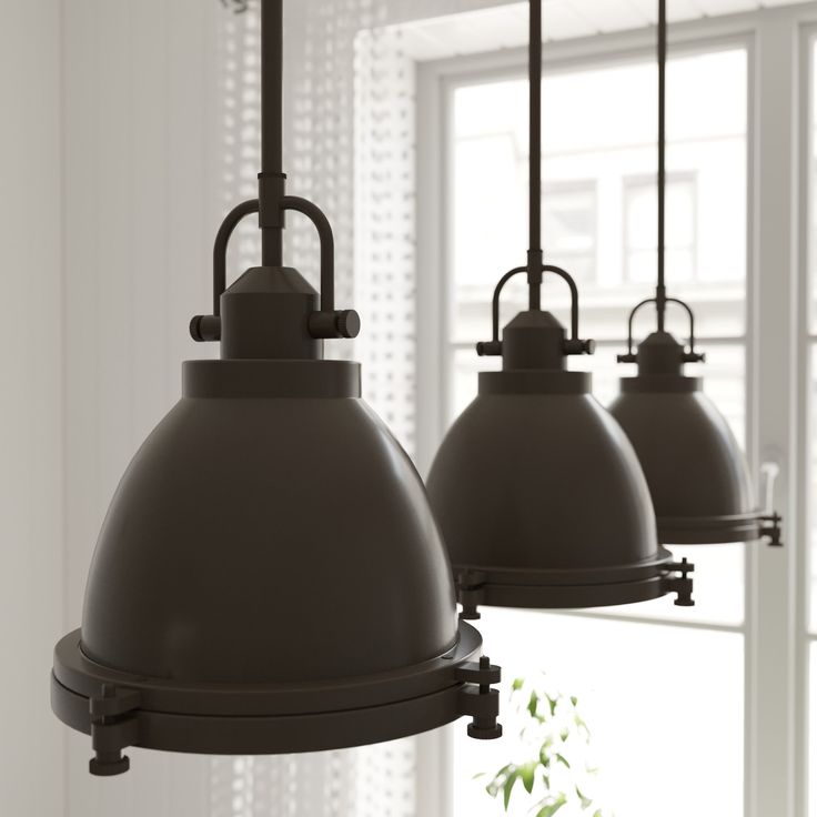 three lights hanging from a ceiling in front of a window