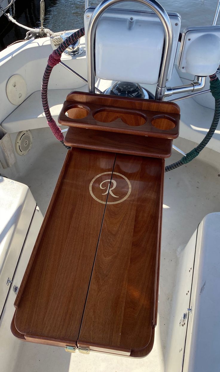 the front end of a boat with its steering wheel and seat on it's deck