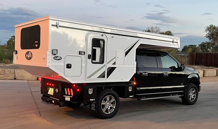 a truck with a camper attached to the back