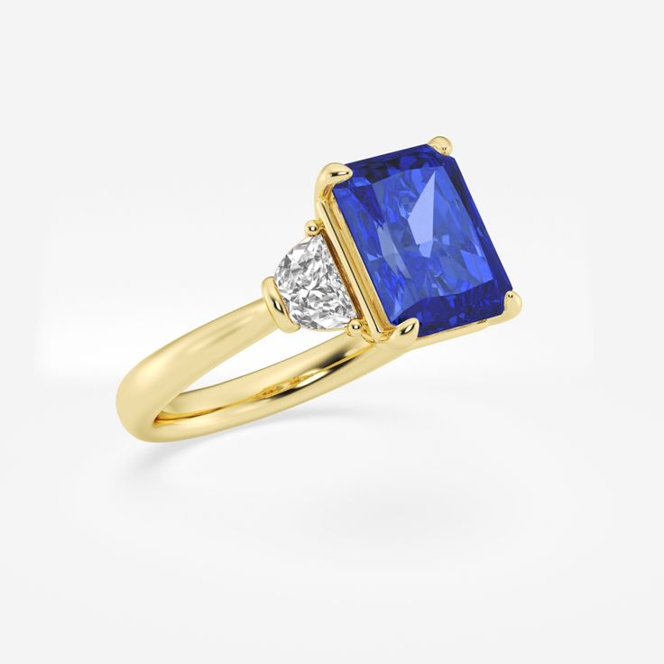 Step into the spotlight with this gorgeous sapphire three stone ring, crafted with a breathtaking radiant cut. This showstopper will draw admirers in with its mesmerizing blue color, while the unique faceting creates a dazzling display of scintillation. Complemented by diamond side stones, this ring strikes the perfect balance between bold and timeless. Radiant Cut Sapphire Ring With Accent Stones, Luxury Square Cut Brilliant Sapphire Ring, Yellow Gold Radiant Cut Sapphire Ring With Center Stone, Luxury Square-cut Brilliant Sapphire Ring, Luxury Square-cut Sapphire Ring With Brilliant Cut, Square-cut Brilliant Sapphire Ring, Elegant Gia Certified Square Cut Sapphire Ring, Square Cut Brilliant Sapphire Ring, Gia Certified Square Cut Sapphire Ring