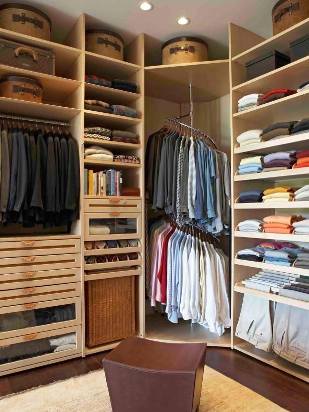 the closet is full of clothes and other items in it's storage area,