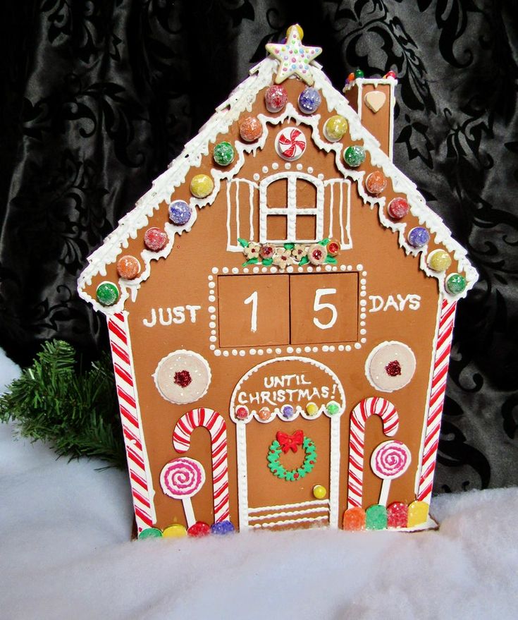 a gingerbread house decorated with candy canes and candies for the holiday season