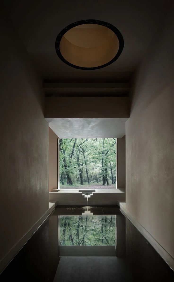 an empty room with a pool in the middle