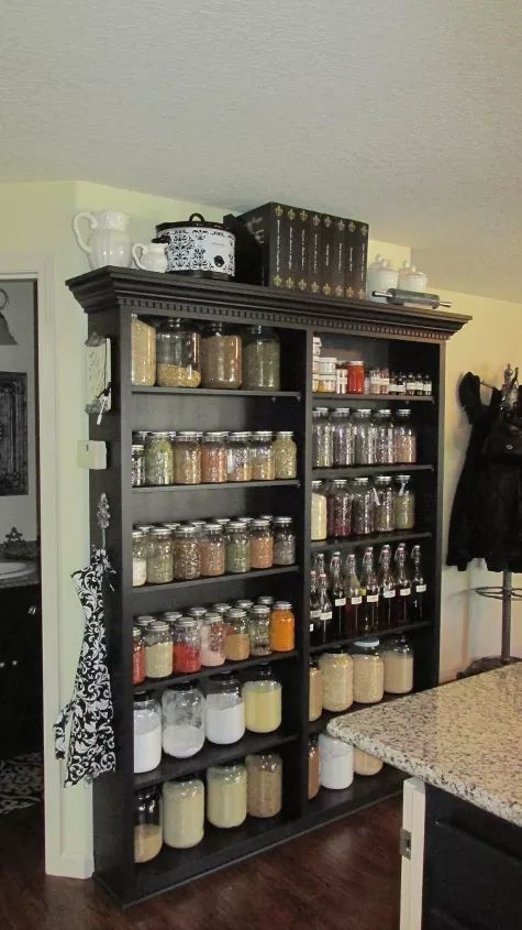 a kitchen filled with lots of different types of spices and condiments on shelves