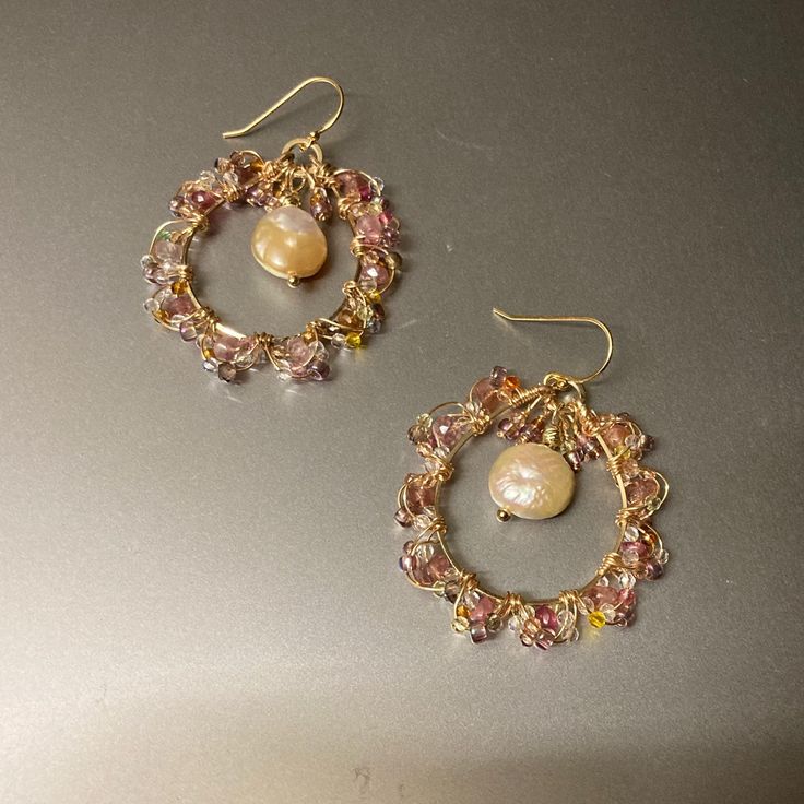 Beautiful and delicate Pearl and gold earrings. Gemstones and glass seed beads wrapped in gold-plated wire. Peach/pink pearl and pink tourmaline create a beautiful combination. Lilac seed beads along with various small seed beads create a unique combination 14K Gold filled earwires, hypoallergenic and safe for delicate skin Comes in box and can be gifted. Gold Wire Wrapped Beaded Earrings In 14k Gold Filled, Gold Wire Wrapped Crystal Earrings For Wedding, Delicate Gold Beaded Earrings, Elegant Hand Wrapped Gold Earrings, Gold Beaded Earrings Wire Wrapped In 14k Gold Filled, Handmade Gold Pearl Beaded Earrings, Handmade Dainty Gold Crystal Earrings, Delicate Gold Wire Wrapped Hoop Earrings, Dainty Pink Wire Wrapped Jewelry