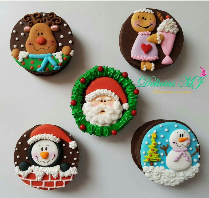 four decorated cookies with santa claus, snowman and other holiday treats on top of each cookie