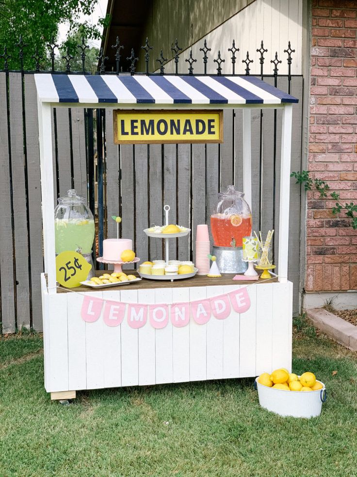 a lemonade stand is set up outside on the grass