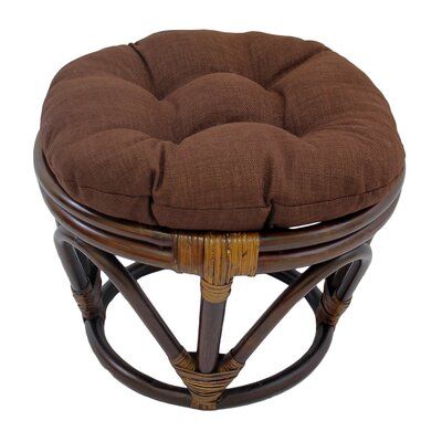 a stool with a brown cushion on it