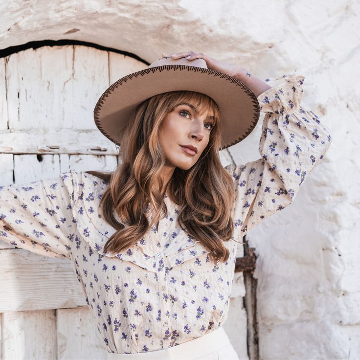 Inspired by the heart of the country scene - Mansfield is a classic pinched crown fedora with western detailing. The stitching detail on the brim , faux leather band with conchos and the statement tear drop shape - this hat is all about walking bold and confident. Features : Brim Size: 3.25" 100% wool Color: Beige Women's one size Wool felt stiff fedora with hand embroidered stitching, faux leather band and western conchos Bohemian Fedora For Ranch Occasions, Bohemian Fedora For Spring Rodeo, Western Hat Bands For Spring, Western Style Hats For Spring, Brown Fedora For Ranch, Country Style Hat Bands For Western-themed Events, Western Fedora For Ranch, Country Style Wide Brim Fitted Fedora, Casual Summer Felt Hat For Ranch