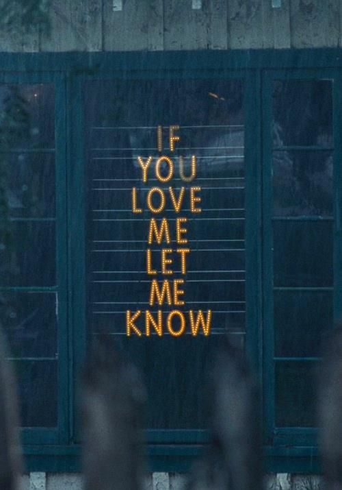 the words if you love me met me know are written in front of a window