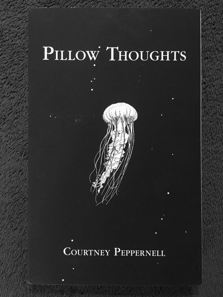 a black book cover with a jellyfish floating in the air on it's side