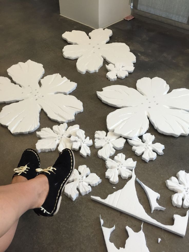 a person standing next to snowflakes on the ground with their feet propped up