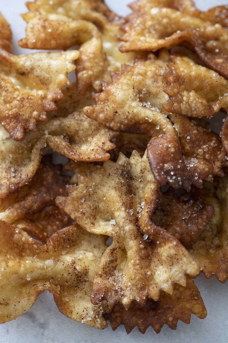 some fried food is sitting on a white paper towel and it looks like they have been cooked